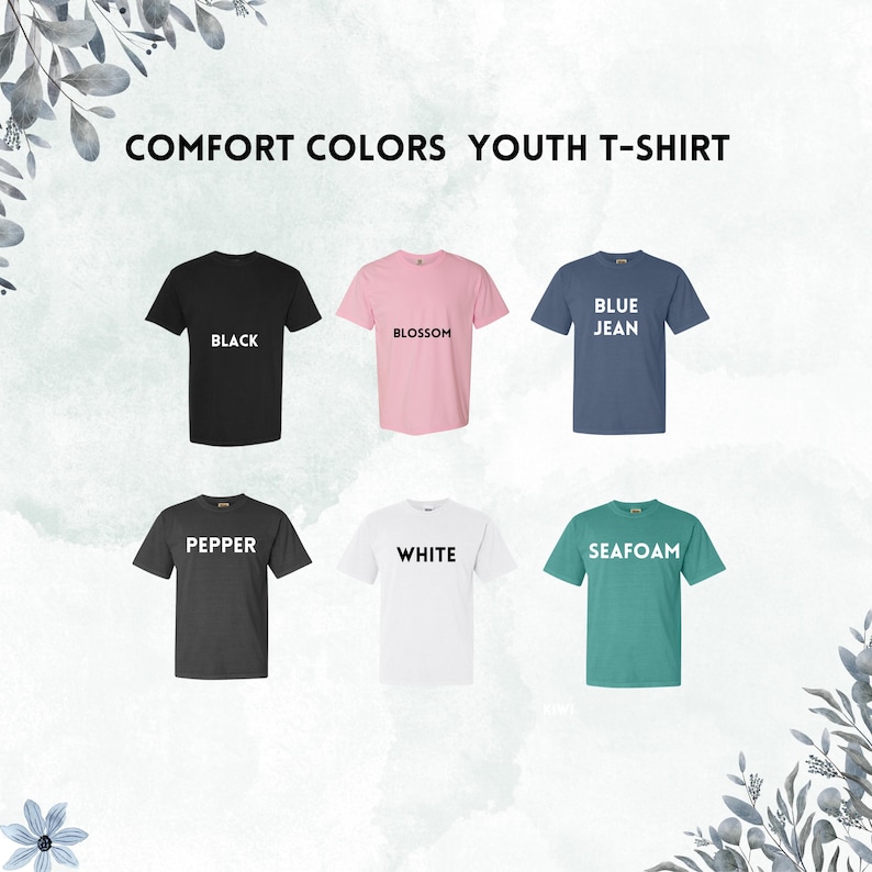 May include: Six youth t-shirts in different colors, including black, white, blue jean, blossom, pepper, and seafoam. Each shirt has a different color name printed on the front.