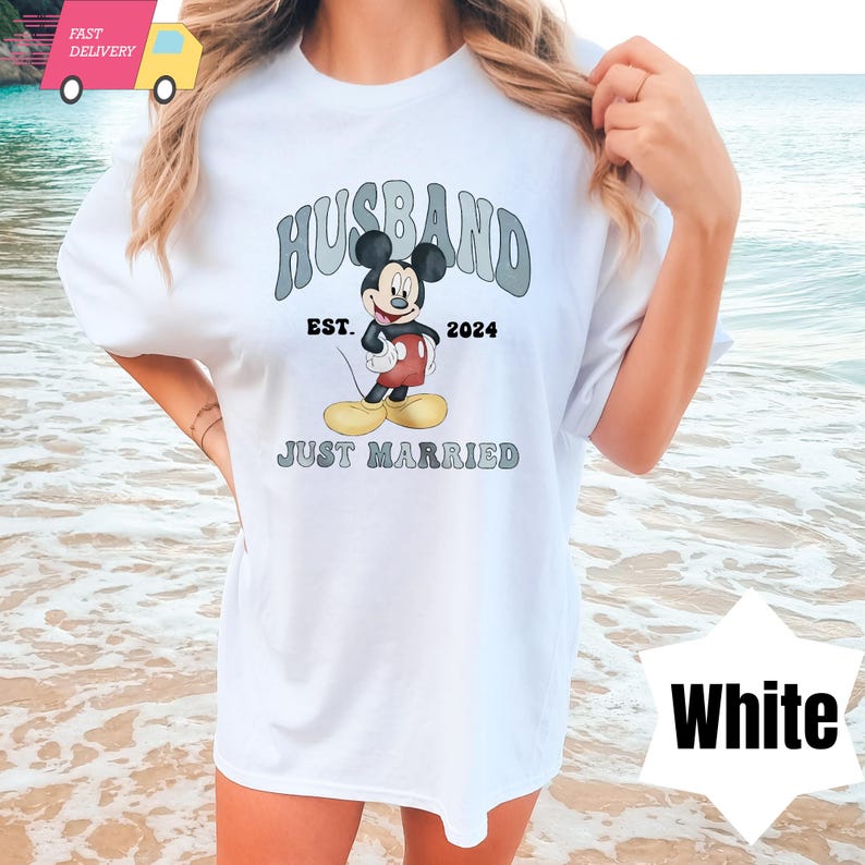 May include: White t-shirt with a graphic of Mickey Mouse and the text "Husband Est. 2024 Just Married".