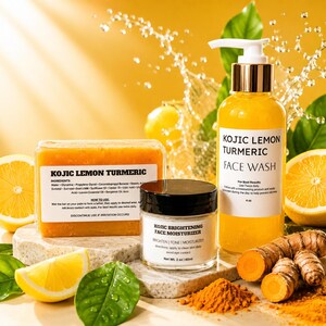 May include: A Kojic Lemon Turmeric soap bar, a Kojic Brightening face moisturizer in a 2 oz jar, and a Kojic Lemon Turmeric face wash in a 4 oz pump bottle. The products are displayed with fresh lemon slices, green leaves, and turmeric root.