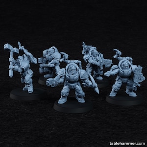 May include: Five gray miniature figures of armored warriors, each posed on a black circular base. The figures are equipped with various weapons, including hammers, guns, and blades. The figures are detailed with armor and helmets.