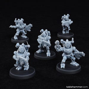 May include: Five gray miniature figurines of futuristic soldiers, each mounted on a black circular base. The soldiers are in various action poses, holding weapons and wearing detailed armor. The image is set against a dark background.