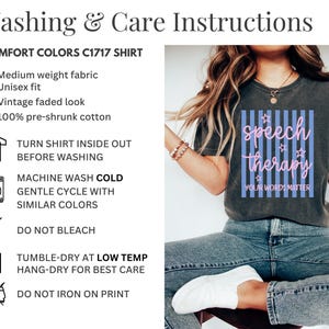 May include: A charcoal gray short-sleeve t-shirt featuring a graphic with vertical light blue stripes, pink cursive text reading speech therapy, and small star outlines. Below the text, the words YOUR WORDS MATTER are printed in white.