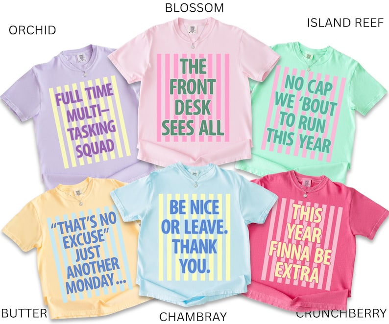 May include: A collection of short-sleeved t-shirts in various colors, each with a unique graphic text design. Colors include orchid, butter, blossom, island reef, chambray, and crunchberry. The text on the shirts includes phrases like "Full Time Multi-Tasking Squad" and "Be Nice or Leave."