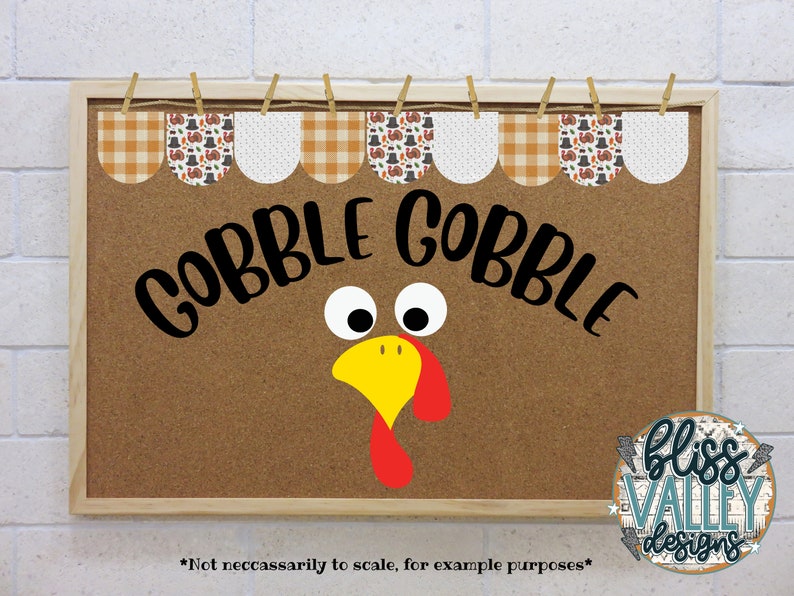 May include: A brown corkboard with a wooden frame, decorated with a Thanksgiving-themed banner. The banner has a checkered pattern and images of turkeys, pilgrims, and pumpkins. The corkboard also has a turkey face with googly eyes and the words "Gobble Gobble" written in black.