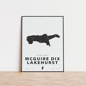 May include: Black and white print of a map of Joint Base McGuire-Dix-Lakehurst, New Jersey. The map shows the base's boundaries and surrounding areas. The text "Joint Base McGuire Dix Lakehurst" is printed below the map.