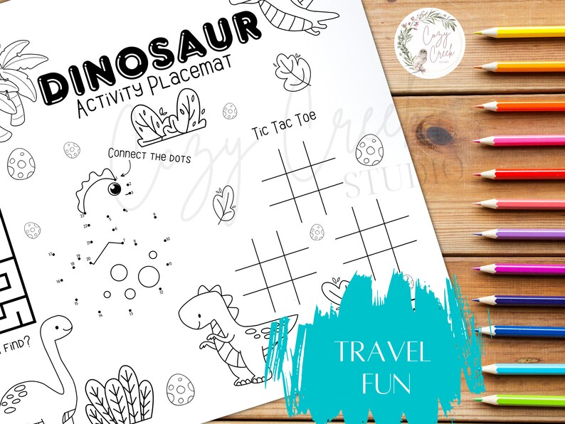 May include: A black and white dinosaur activity placemat with the text "DINOSAUR ACTIVITY PLACEMAT". The placemat includes connect-the-dots, tic-tac-toe, and other activities. The words "TRAVEL FUN" are also visible.