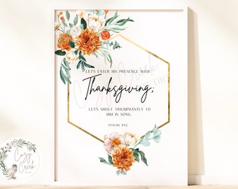 May include: A framed print with floral arrangements and text. The artwork features orange and white flowers, green leaves, and a gold geometric shape. The text reads "Let's enter His presence with Thanksgiving; Let's shout triumphantly to Him in song. Psalms 952."