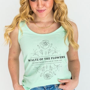 May include: A mint green tank top with a floral design and the text "Waltz of the Flowers The Best Seven Minutes of Your Life".