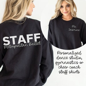 May include: Black long-sleeved sweatshirt with white text on the back that reads "STAFF Metropolitan Ballet". The front of the sweatshirt has white text that reads "Ms. Jasmine".