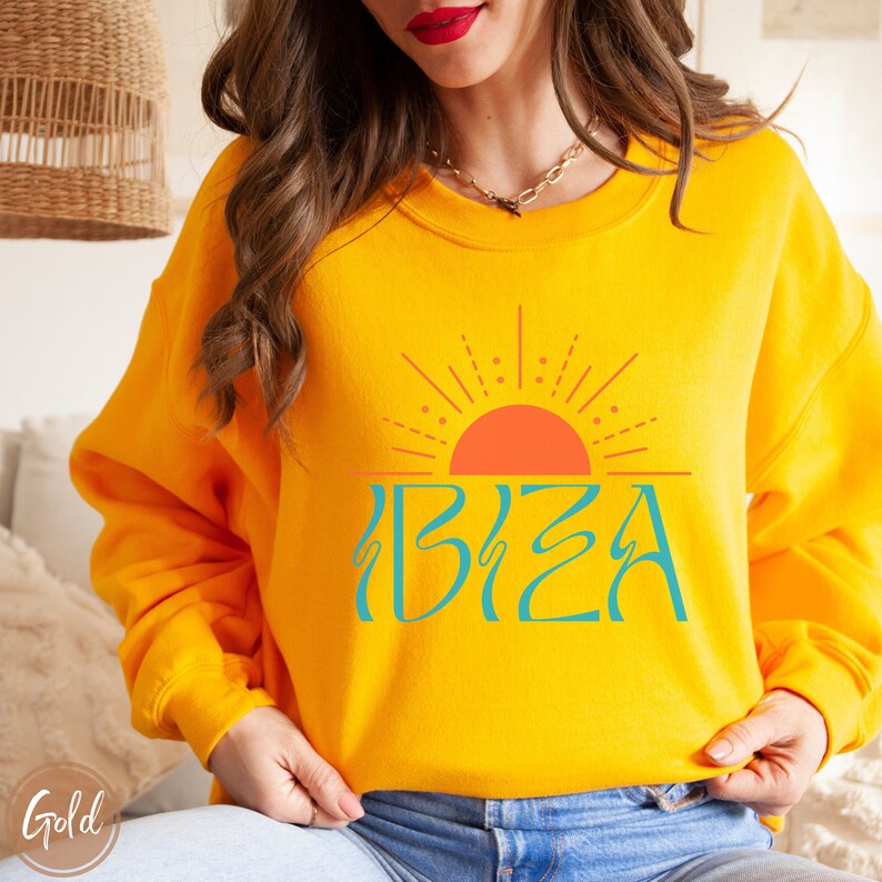 May include: Yellow sweatshirt with a graphic of a stylised sun and the word "IBIZA" in turquoise blue.