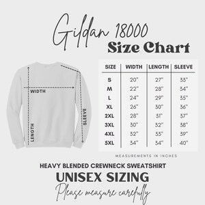 May include: A size chart for Gildan 18000 heavy blended crewneck sweatshirts. The chart shows the width, length, and sleeve length in inches for sizes S through 5XL.
