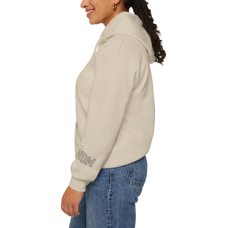 May include: A light grey hooded sweatshirt with the word "remarkable" printed in black on the left sleeve.