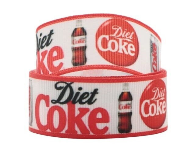 May include: White and red ribbon with a repeating pattern of Diet Coke logos, including a bottle, a can, and a red circle with the text "Diet Coke".