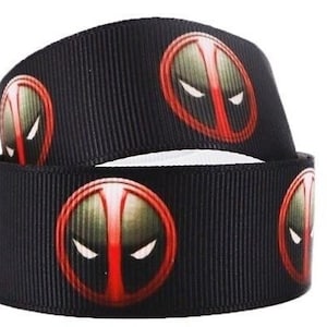 May include: Black ribbon with a repeating pattern of red and black Deadpool masks.