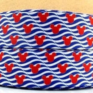 May include: Two rolls of ribbon with a repeating pattern of red Mickey Mouse heads on a blue and white wavy background. The ribbon is likely used for crafting, gift wrapping, or other decorative purposes.