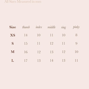 May include: A 79th Street Nails Size Guide chart on a light pink background. The text reads 79th Street Nails Size Guide and All Sizes Measured in mm. A table lists sizes XS, S, M, and L with corresponding measurements in mm for each finger.