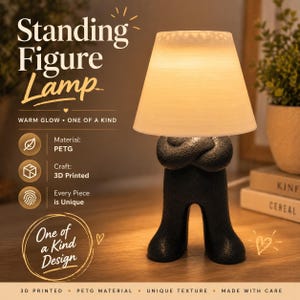 May include: A black standing figure lamp with a warm glow, featuring a unique texture and a 3D-printed design. The lamp has a cream-colored lampshade and is made of PETG material. The text on the image says "Standing Figure Lamp".