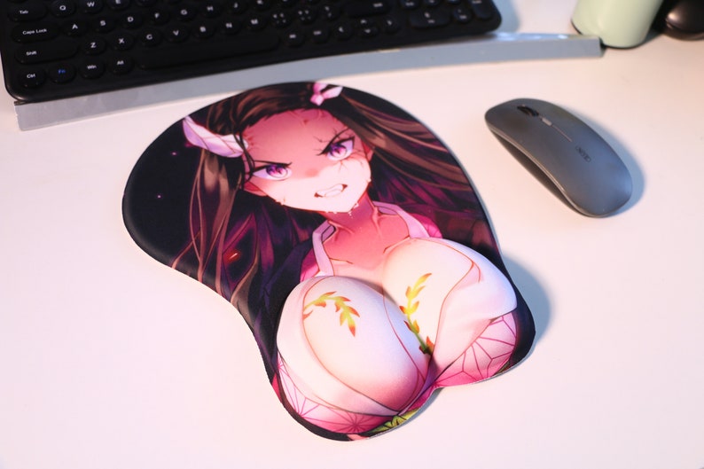 May include: A pink and white anime-style mousepad with a female character with long black hair and a pink and white outfit. The character has a fierce expression and is wearing a white headband with a pink flower.