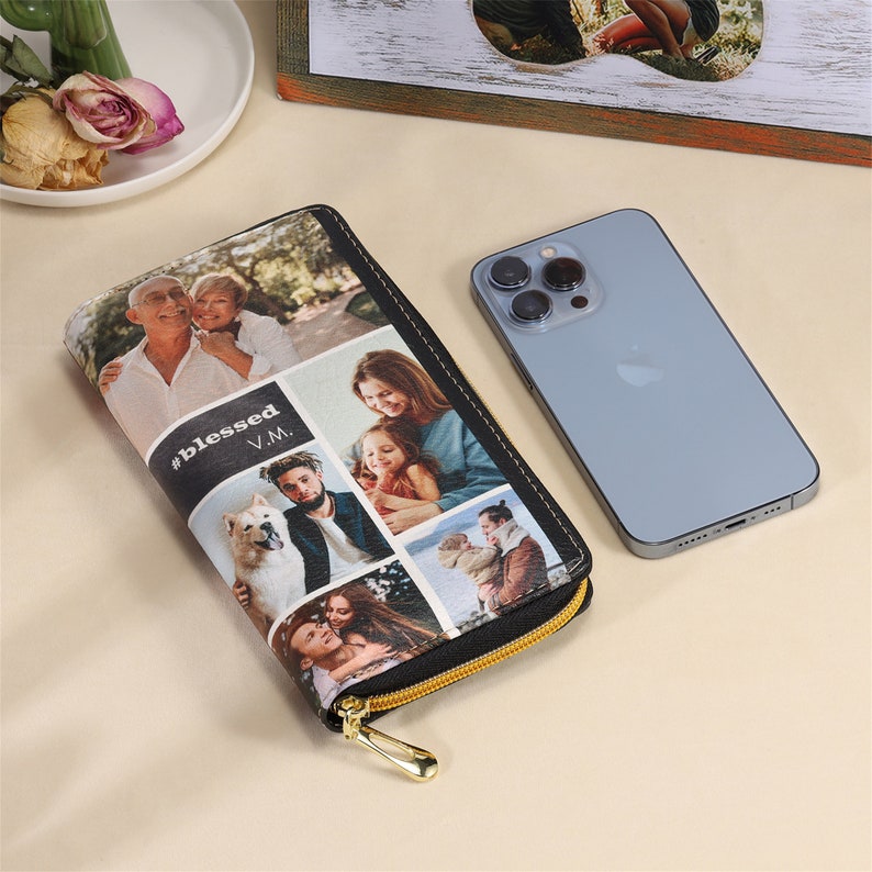 Puede incluir: Cartera negra con cremallera con un collage de fotos familiares y el texto "#blessed V.M." impreso en la parte delantera.