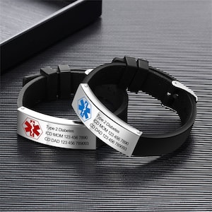 May include: Two black medical alert bracelets with silver metal plates. One plate has a red medical symbol and the other has a blue medical symbol. Both plates have the text "Type 2 Diabetes" and contact information.