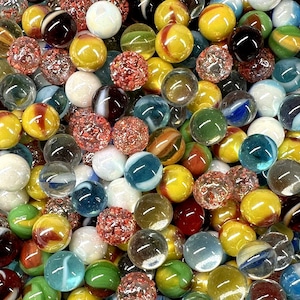 May include: A large collection of colorful glass marbles in various patterns and colors, including red, blue, green, yellow, white, and black.