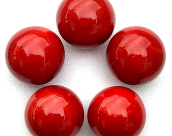 May include: Five glossy, round, red beads arranged in a circular pattern. The beads have a smooth, reflective surface, and the color is a vibrant, solid red. The beads are likely used for jewelry making or crafting.