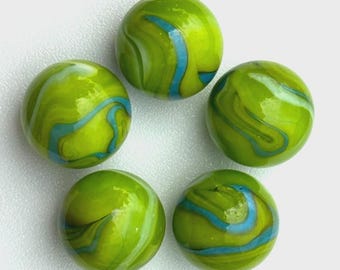 May include: Five green glass marbles with blue and white swirls. The marbles are arranged in a circular pattern, each with a unique pattern of color. The marbles have a glossy finish and are set against a white background.