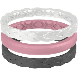 May include: A stack of three silicone rings in white, pink, and black. The top and bottom rings have a braided design, while the middle ring is a solid band. The rings are stacked on top of each other.