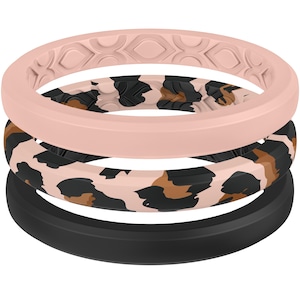 May include: Three silicone rings stacked on top of each other. The top ring is a light pink with a geometric pattern. The middle ring has a leopard print design. The bottom ring is solid black.