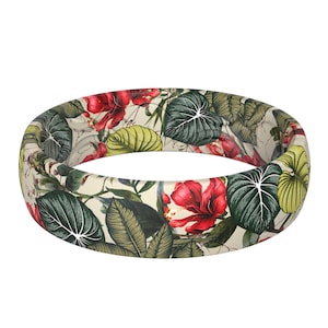 May include: A floral patterned ring featuring red hibiscus flowers, green and yellow leaves, and a cream background. The ring is a continuous band, showcasing a tropical botanical design.