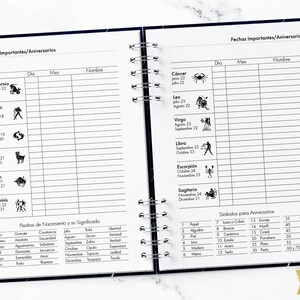 May include: A black and white planner with a spiral binding. The left page has a list of zodiac signs with their dates and symbols. The right page has a list of important dates and anniversaries with columns for day, month, and name. The bottom of the page has a table of birthstones and their meanings.