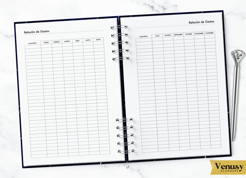 May include: A black and white planner with two pages open. The left page has a table with the months of the year listed across the top and the word "Concepto" at the top of the first column. The right page has a table with the months of the year from June to December listed across the top and the word "Concepto" at the top of the first column. The planner has a spiral binding.