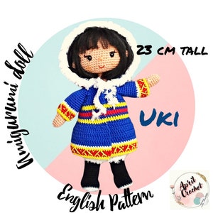 May include: Crochet pattern for a 23-inch tall amigurumi doll wearing a blue, yellow, and red striped coat with a white hood. The doll is named "Uki" and the pattern is in English.