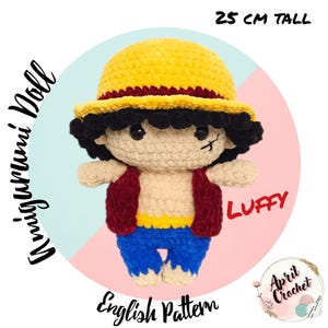 May include: A handmade amigurumi doll of the character Luffy, 25 cm tall. The doll has a yellow hat with a red band, black hair, a red vest, blue pants, and a tan body. The text "Luffy" is visible.