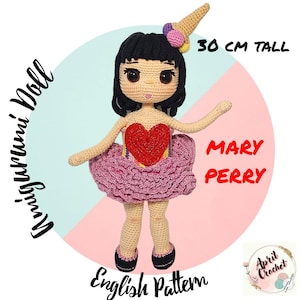 May include: Crochet doll pattern for a 30-inch tall doll with black hair, a pink tutu, and a red heart on her chest. The pattern is called "Mary Perry" and is available in English.