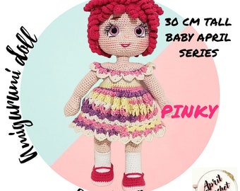 May include: A crocheted doll with pink hair, a pink and yellow dress, and red shoes. The doll is 30 inches tall and is part of the Baby April series. The doll is named Pinky.