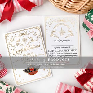 May include: A white greeting card with gold foil accents featuring the text Congratulations, You Are An Approved Member Of, and Santa's Sleigh Flight Crew. The card includes illustrations of reindeer, a star, and a bow, with a metal pin attached.