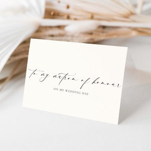 May include: A white card with black calligraphy that reads "To my matron of honour on my wedding day".