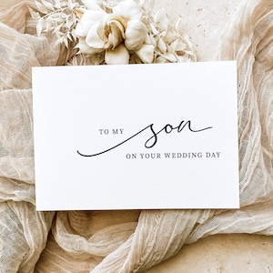May include: A white card with black text that reads "To my son on your wedding day".