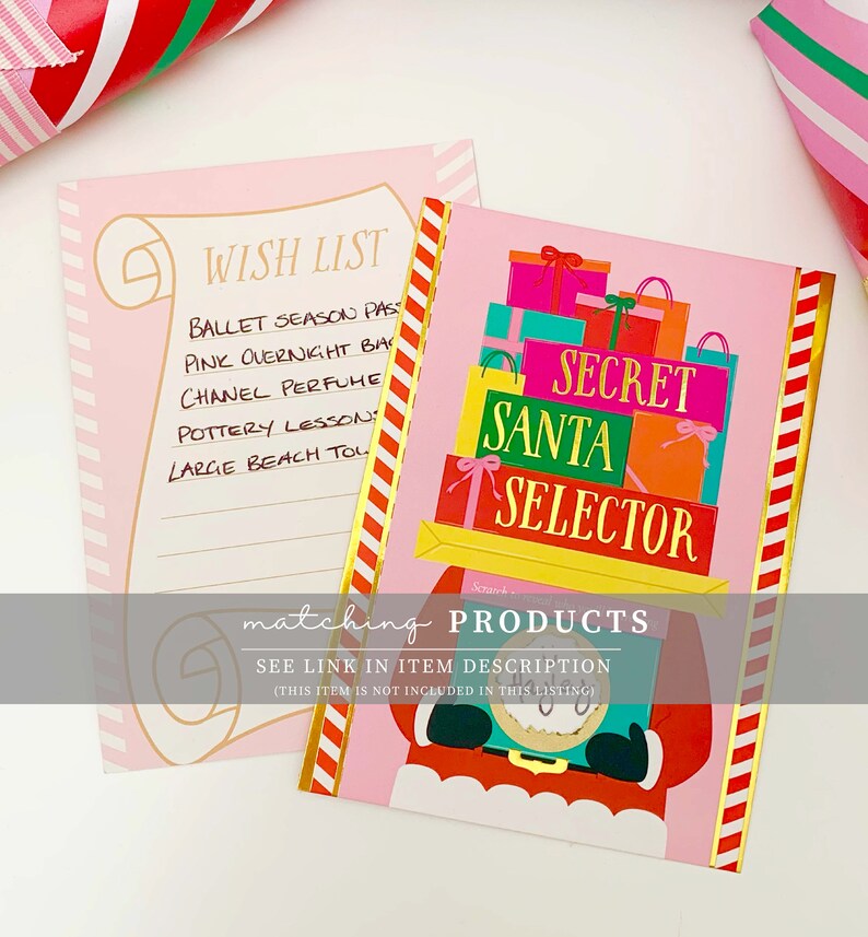 May include: Pink and gold Secret Santa Selector card with a Santa Claus illustration. A pink wish list notepad is next to the card. Both items have gold accents and are decorated with red and white stripes.
