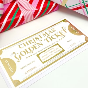 May include: A gold-coloured Christmas Golden Ticket with the text "Christmas Golden Ticket" and "Hooray" and "Yipee". The ticket is presented to Cameron and redeemable for tickets to Hamilton at the Sydney Lyric Theatre. Gift-wrapped presents are in the background.