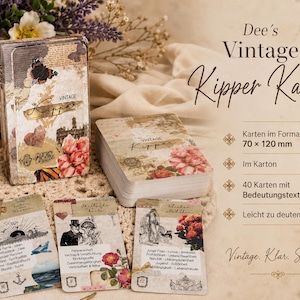May include: A vintage-style deck of Kipper cards with a decorative box. The box and cards feature floral and butterfly illustrations, with text that reads "Vintage Kipper Karten." The cards measure 70 x 120 mm.