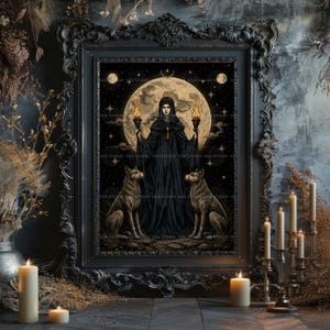 May include: A framed wall art print featuring a central figure in a black hooded cloak holding two lit torches, flanked by two wolves. The background displays a large full moon, stars, and a dark sky. The frame is ornate, black, and rectangular.