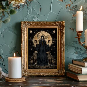 May include: A framed art print featuring a dark-robed figure holding two lit torches, flanked by two wolves under a large full moon and starry sky. The artwork is encased in an ornate, antique-style gold frame with intricate relief detailing.