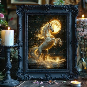 May include: A framed art print featuring a white unicorn rearing up in front of a full moon. The artwork is set against a dark, starry background with golden accents. The frame is black and ornate, with a candle and candlestick in the foreground.