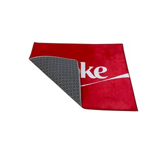 May include: Red doormat with the word "Coke" in white lettering. The back of the doormat is gray with a diamond pattern.