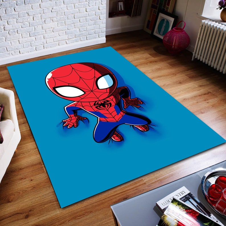 May include: A blue rug with a cartoon image of Spider-Man in a red and blue suit. The Spider-Man is in a crouching position with his arms outstretched.