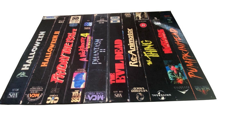May include: A collection of VHS tapes featuring horror movie titles, including Halloween, Friday the 13th, Phantasm, The Evil Dead, Re-Animator, The Thing, and Pumpkinhead.