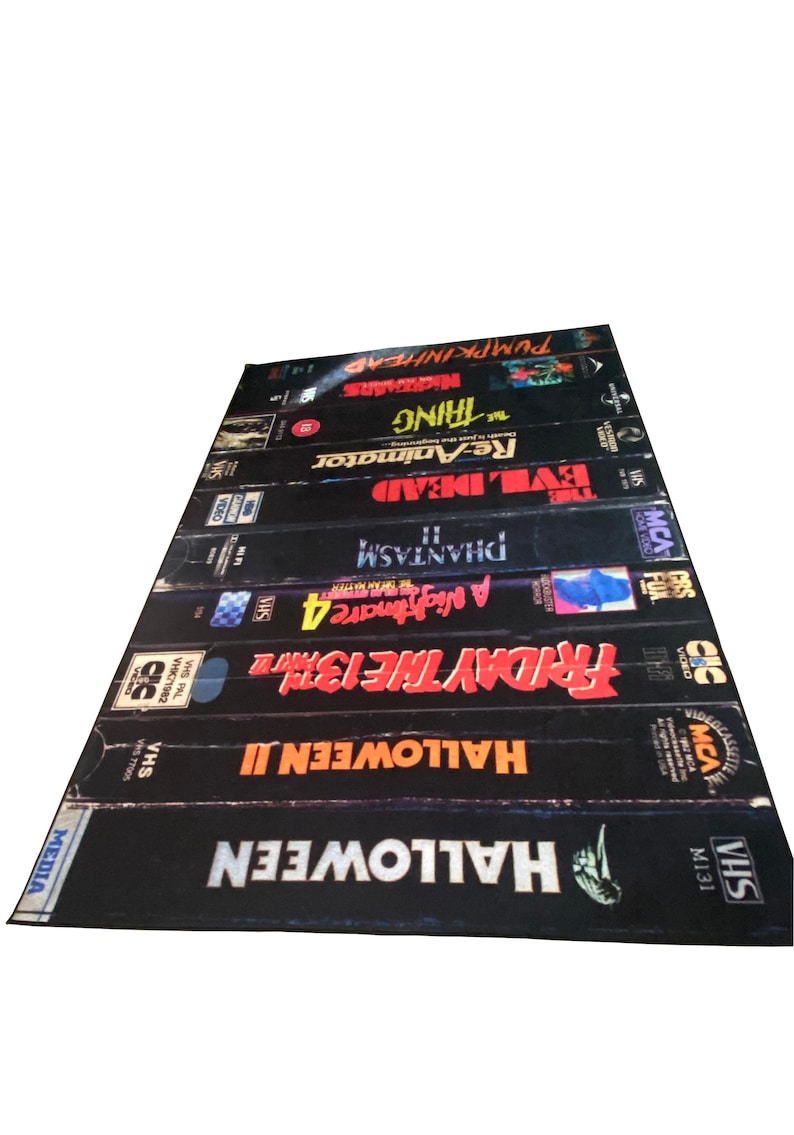 May include: A stack of VHS tapes featuring horror movie titles including Halloween, Friday the 13th, A Nightmare on Elm Street, Phantasm, Evil Dead, Re-Animator, The Thing, and Pumpkinhead.