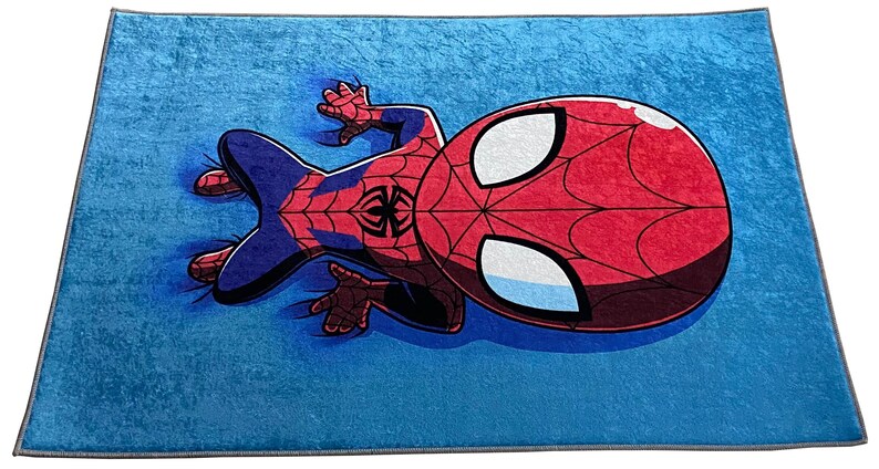 May include: A blue rug with a cartoon image of Spiderman in a red and blue suit. Spiderman is lying on his back with his arms and legs outstretched.